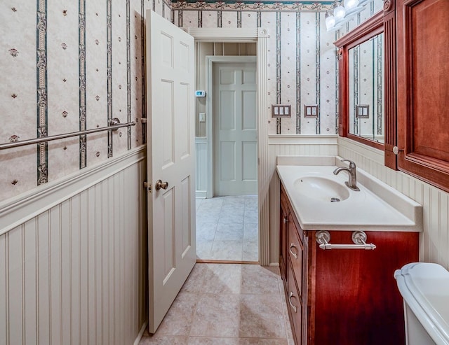 2250 Hickory Dr, Spartanburg, SC 29302 - bathroom featuring wallpapered walls, vanity, a wainscoted wall, and a decorative wall
