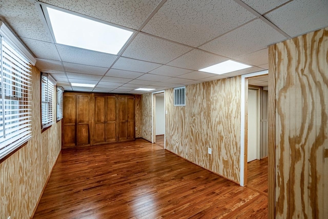 2250 Hickory Dr, Spartanburg, SC 29302 - basement with wood-type flooring, a drop ceiling, and wood walls