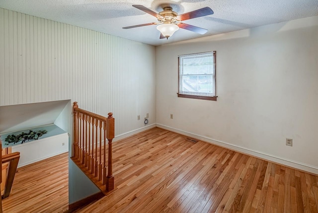 2250 Hickory Dr, Spartanburg, SC 29302 - empty room with wood finished floors, ceiling fan, and a textured ceiling