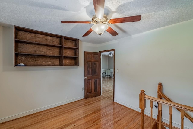 2250 Hickory Dr, Spartanburg, SC 29302 - unfurnished room with wood finished floors, ceiling fan, and a textured ceiling
