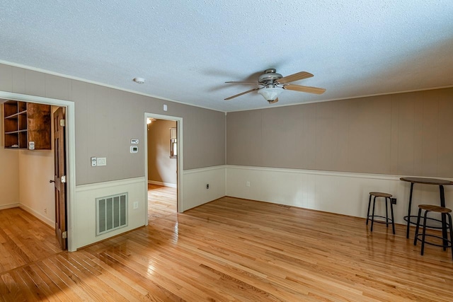 2250 Hickory Dr, Spartanburg, SC 29302 - unfurnished room with a ceiling fan, light wood finished floors, a textured ceiling, and ornamental molding