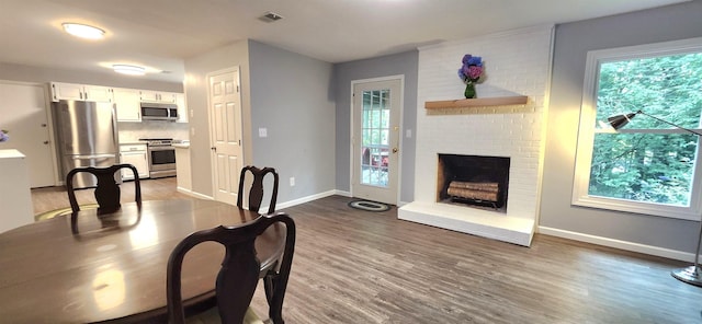 192 Wellesley Dr, Spartanburg, SC 29307 - dining room with dark wood finished floors, healthy amount of natural light, and a brick fireplace
