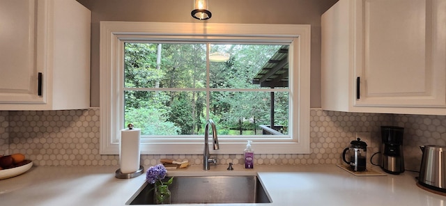 192 Wellesley Dr, Spartanburg, SC 29307 - kitchen featuring backsplash, light countertops, white cabinets, and plenty of natural light