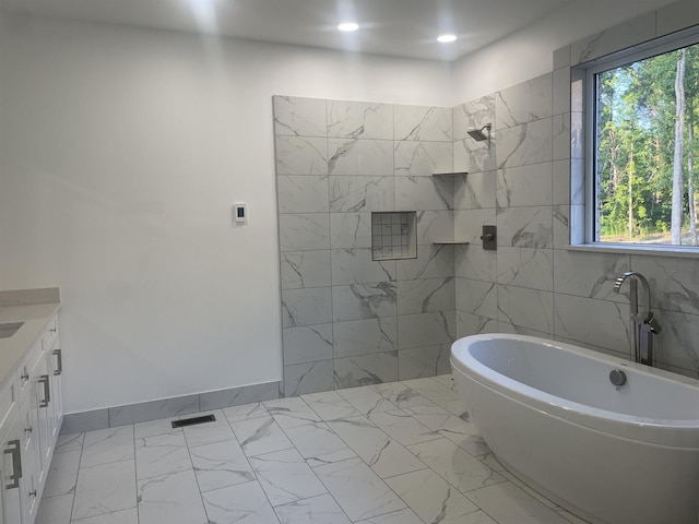 115 Hickory Hollow Rd, Inman, SC 29349 - bathroom featuring marble look tile flooring, a freestanding bath, vanity, tiled shower, and recessed lighting