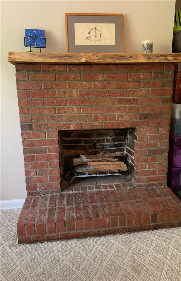 107 S Poplar Ave, Landrum, SC 29356 - detailed view of a brick fireplace and carpet