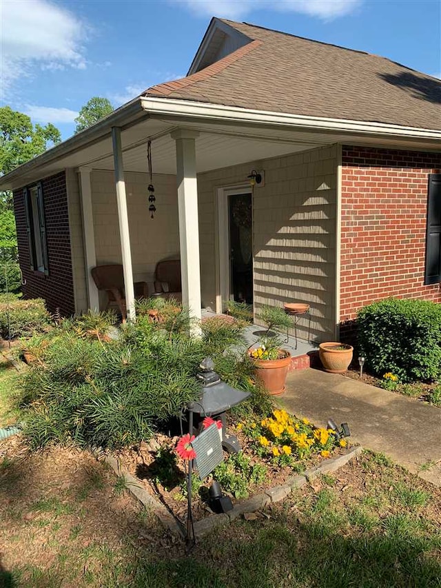 107 S Poplar Ave, Landrum, SC 29356 - view of side of property featuring brick siding and roof with shingles