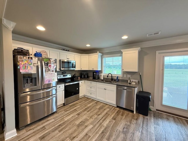 115 Rolling Mill Rd, Gaffney, SC 29340 - kitchen with appliances with stainless steel finishes, ornamental molding, white cabinetry, light wood-type flooring, and recessed lighting