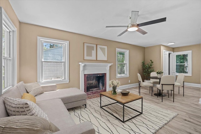 504 Hilda St, Spartanburg, SC 29306 - living room featuring healthy amount of natural light, light wood finished floors, a brick fireplace, and ceiling fan