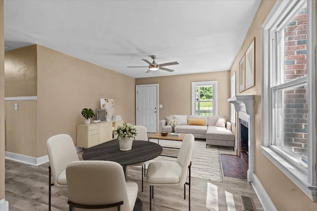 504 Hilda St, Spartanburg, SC 29306 - dining area featuring ceiling fan, light wood-style flooring, and a fireplace