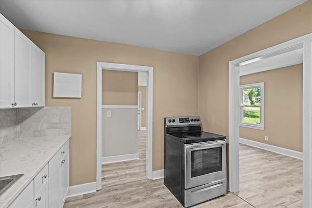 504 Hilda St, Spartanburg, SC 29306 - kitchen featuring electric range, white cabinetry, light wood-style flooring, and light stone counters