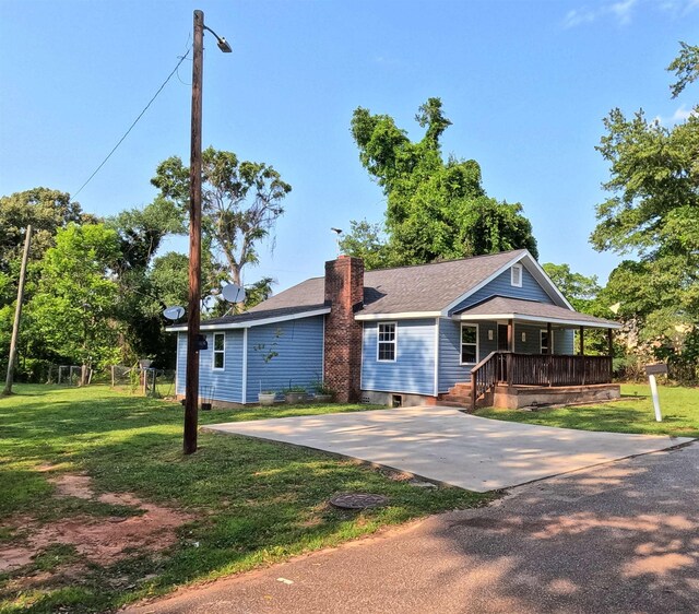 105 Anderson St, Spartanburg, SC 29301 - view of front of home with covered porch, a chimney, a front lawn, and roof with shingles
