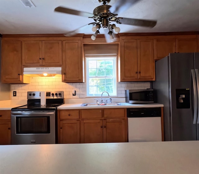 105 Anderson St, Spartanburg, SC 29301 - kitchen with stainless steel appliances, under cabinet range hood, a ceiling fan, light countertops, and tasteful backsplash