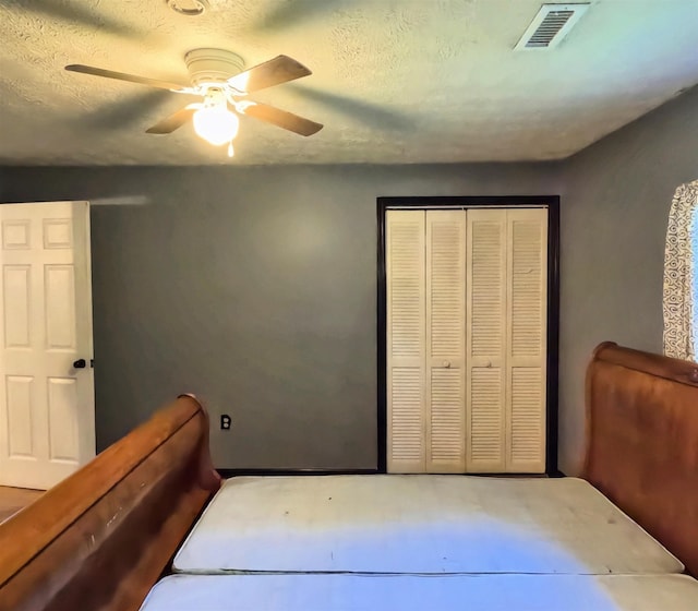 105 Anderson St, Spartanburg, SC 29301 - bedroom with ceiling fan, a closet, and a textured ceiling