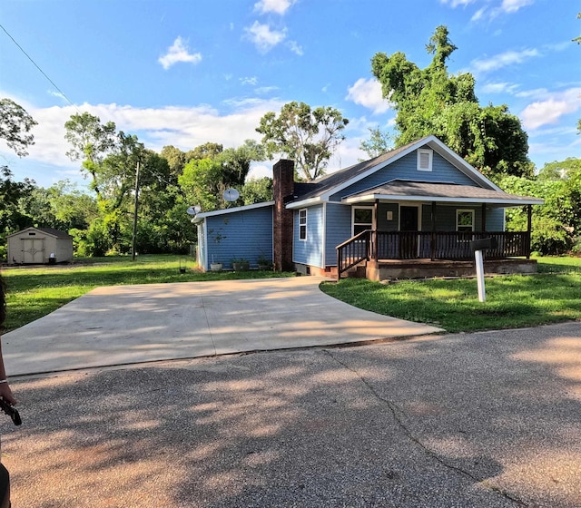 105 Anderson St, Spartanburg, SC 29301 - view of front of property featuring covered porch, a shed, a chimney, a front yard, and driveway
