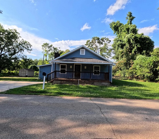 105 Anderson St, Spartanburg, SC 29301 - view of front of home featuring a storage shed, a porch, a chimney, and a front lawn