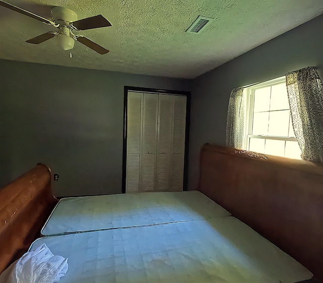 105 Anderson St, Spartanburg, SC 29301 - unfurnished bedroom with a closet, ceiling fan, and a textured ceiling