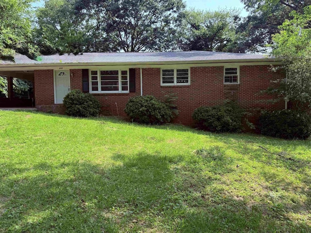 213 Loring St, Spartanburg, SC 29302 - single story home with a front lawn, brick siding, and an attached carport
