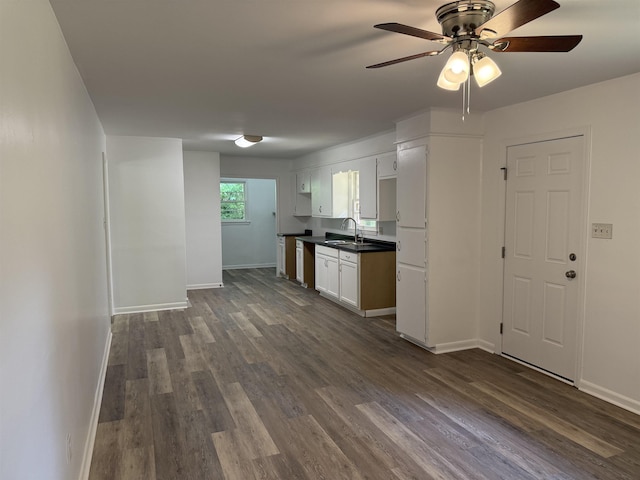213 Loring St, Spartanburg, SC 29302 - kitchen with dark countertops, dark wood-type flooring, ceiling fan, and white cabinetry
