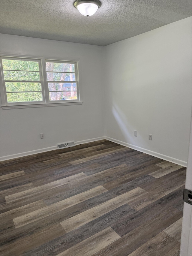 213 Loring St, Spartanburg, SC 29302 - unfurnished room featuring a textured ceiling and dark wood-style floors
