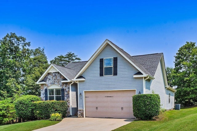 30 Caperton Way, Greer, SC 29651 - traditional-style house featuring driveway, a garage, stone siding, roof with shingles, and a front yard