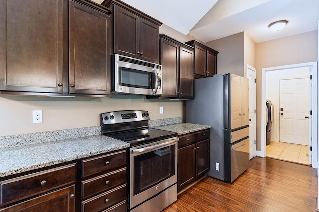 30 Caperton Way, Greer, SC 29651 - kitchen featuring stainless steel appliances, dark brown cabinetry, dark wood-style floors, lofted ceiling, and washer and clothes dryer