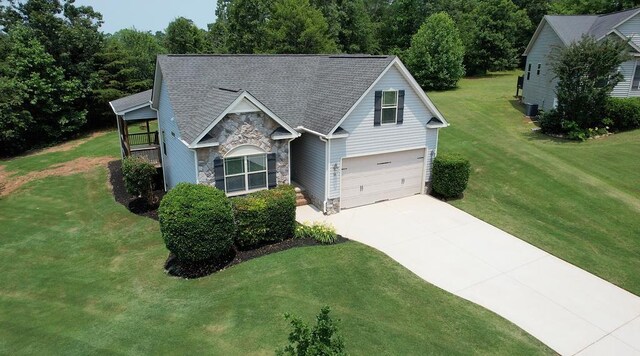 30 Caperton Way, Greer, SC 29651 - view of front facade with stone siding, concrete driveway, a front lawn, and an attached garage