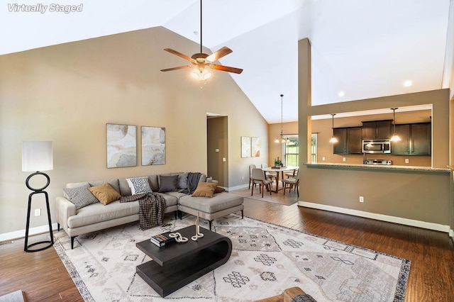 30 Caperton Way, Greer, SC 29651 - living area featuring high vaulted ceiling, wood finished floors, ceiling fan, and a chandelier