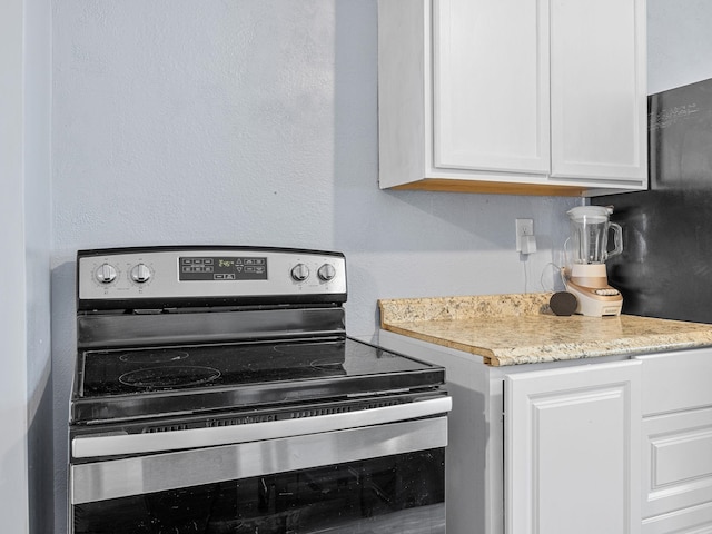 24 Oak St, Spartanburg, SC 29306 - kitchen with stainless steel range with electric cooktop and white cabinets