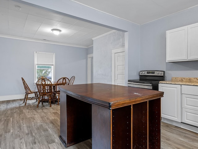 24 Oak St, Spartanburg, SC 29306 - kitchen with stainless steel electric range oven, crown molding, light wood-style floors, white cabinetry, and light stone countertops