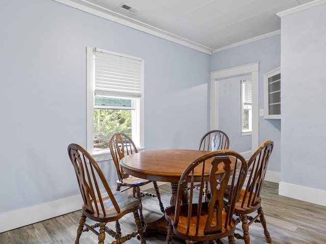 24 Oak St, Spartanburg, SC 29306 - dining area featuring wood finished floors and crown molding