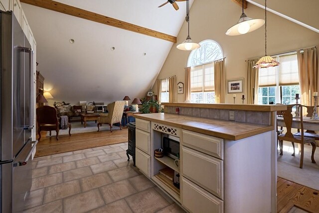 226 John Smith Rd, Columbus, NC 28722 - kitchen featuring tile counters, high quality fridge, high vaulted ceiling, beamed ceiling, and a ceiling fan