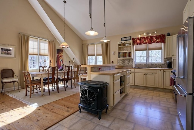 226 John Smith Rd, Columbus, NC 28722 - kitchen with cream cabinets, high end refrigerator, hanging light fixtures, a wood stove, and light countertops