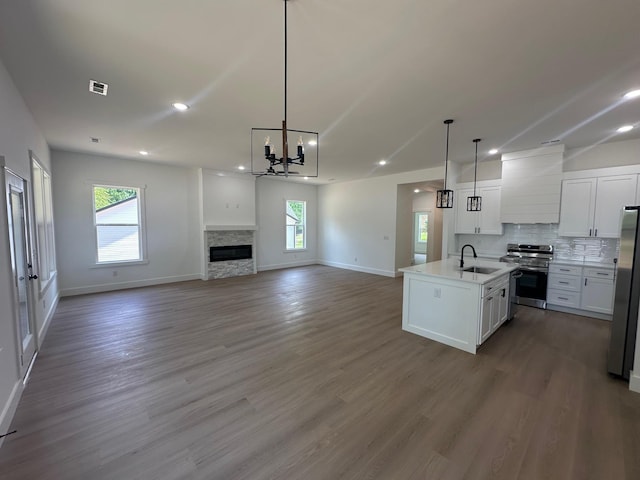 953 Mike Cir, Boiling Springs, SC 29303 - kitchen featuring stainless steel appliances, custom range hood, open floor plan, white cabinets, and a chandelier