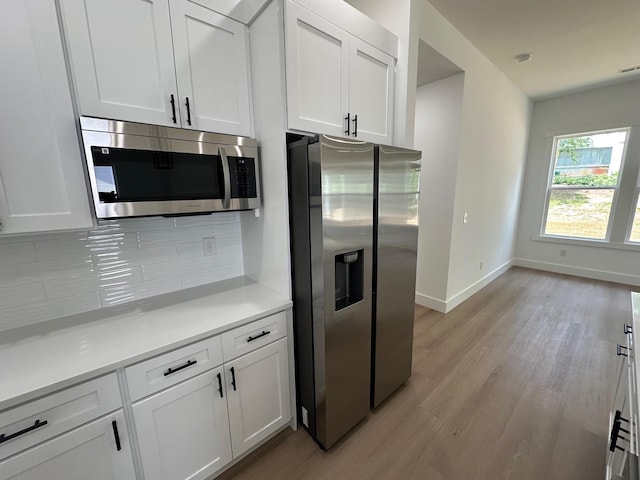 953 Mike Cir, Boiling Springs, SC 29303 - kitchen featuring stainless steel appliances, light wood-style floors, tasteful backsplash, light countertops, and white cabinets