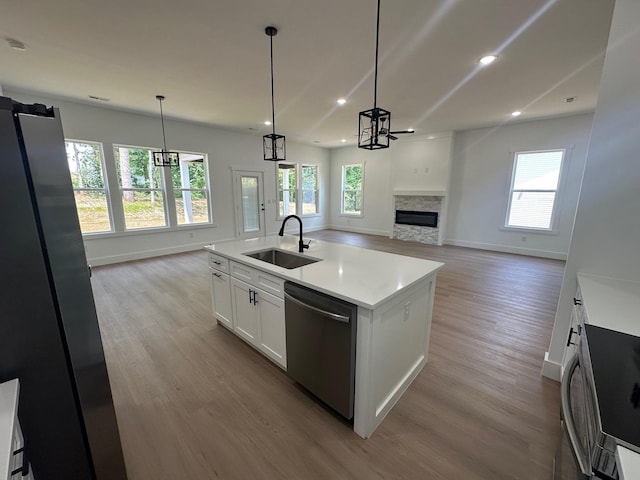 953 Mike Cir, Boiling Springs, SC 29303 - kitchen with dishwasher, light wood-style floors, open floor plan, a stone fireplace, and light countertops