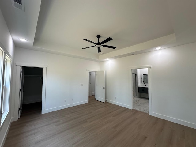 953 Mike Cir, Boiling Springs, SC 29303 - unfurnished bedroom with a tray ceiling, wood finished floors, recessed lighting, ensuite bathroom, and a ceiling fan