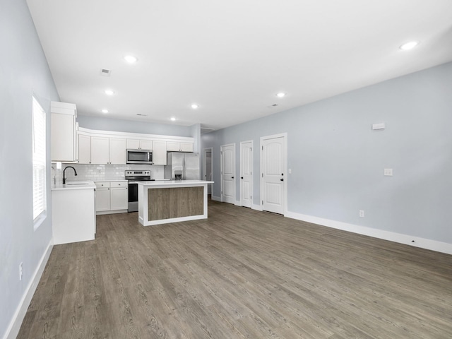 5 S Howard St, Inman, SC 29349 - kitchen with stainless steel appliances, open floor plan, a center island, wood finished floors, and light countertops