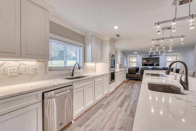 825 N Franklin Rd, Greenville, SC 29617 - kitchen with appliances with stainless steel finishes, open floor plan, white cabinets, light stone counters, and crown molding