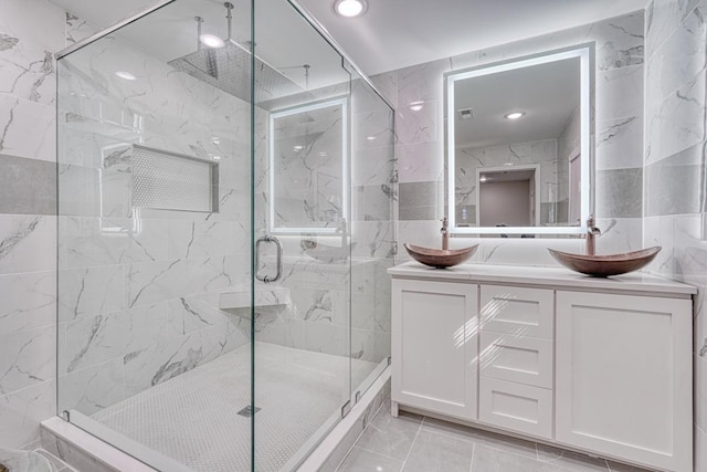 825 N Franklin Rd, Greenville, SC 29617 - full bathroom featuring a marble finish shower, vanity, tile walls, recessed lighting, and marble look tile flooring
