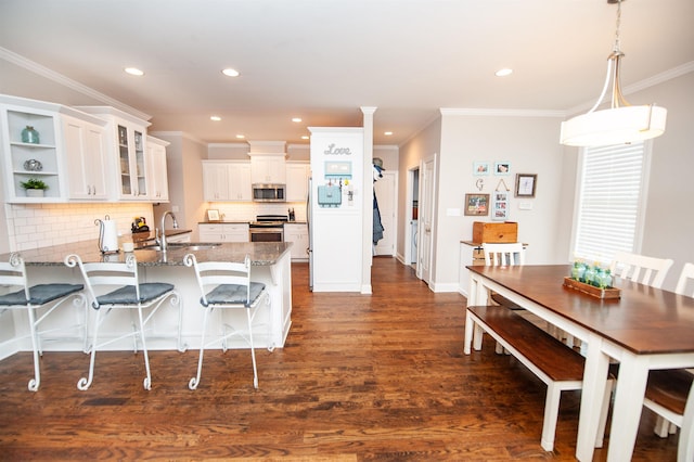 211 Piper Glen Ln, Inman, SC 29349 - kitchen with appliances with stainless steel finishes, a peninsula, dark wood-style flooring, stone counters, and white cabinetry
