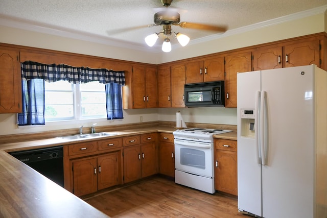 4421 New Cut Rd, Inman, SC 29349 - kitchen featuring black appliances, brown cabinetry, a textured ceiling, light countertops, and crown molding