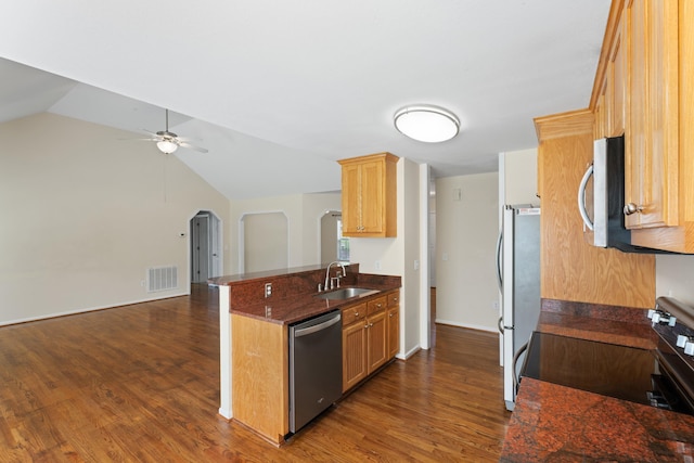 719 S Bomar Ave, Landrum, SC 29356 - kitchen with appliances with stainless steel finishes, a peninsula, dark wood-style floors, arched walkways, and a ceiling fan