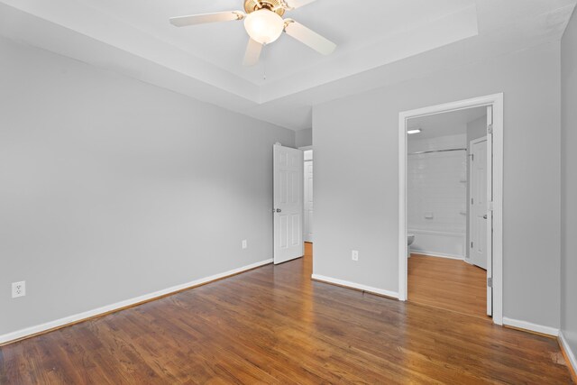 719 S Bomar Ave, Landrum, SC 29356 - unfurnished bedroom featuring wood finished floors, a raised ceiling, and ceiling fan