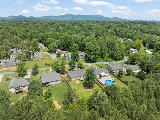 719 S Bomar Ave, Landrum, SC 29356 - aerial perspective of suburban area featuring a heavily wooded area and a mountainous background