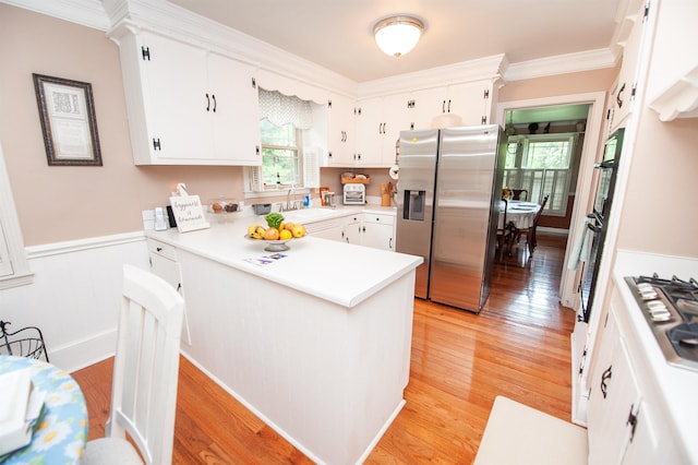147 Hillbrook Dr, Spartanburg, SC 29307 - kitchen featuring appliances with stainless steel finishes, a peninsula, healthy amount of natural light, light wood-style flooring, and ornamental molding