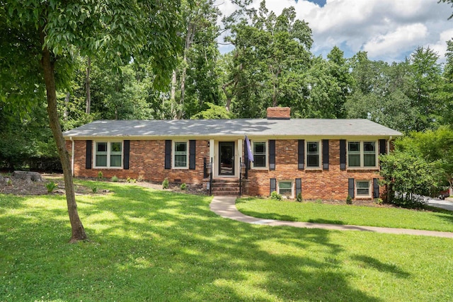 147 Hillbrook Dr, Spartanburg, SC 29307 - view of front of house with a chimney, brick siding, and a front yard