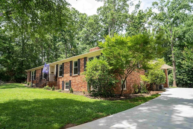 147 Hillbrook Dr, Spartanburg, SC 29307 - view of front of house with brick siding, a front lawn, and a chimney