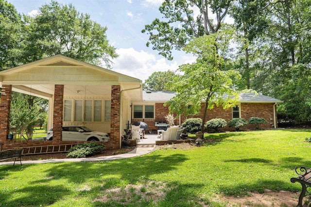 147 Hillbrook Dr, Spartanburg, SC 29307 - rear view of property featuring a lawn, a patio area, and brick siding