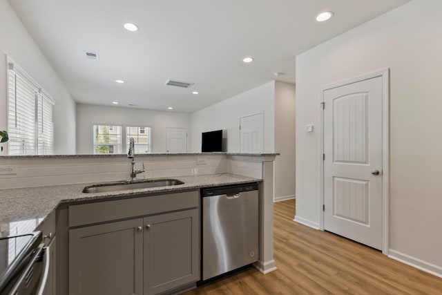 3008 Olivette Pl, Duncan, SC 29334 - kitchen with stainless steel dishwasher, gray cabinetry, decorative backsplash, light wood finished floors, and light stone counters
