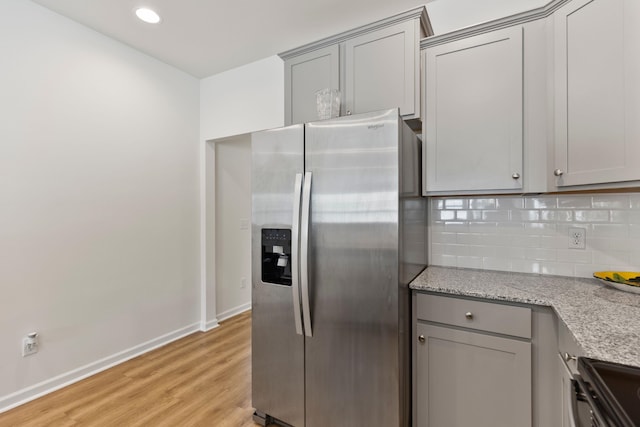 3008 Olivette Pl, Duncan, SC 29334 - kitchen featuring stainless steel fridge, gray cabinetry, black / electric stove, light wood-type flooring, and backsplash
